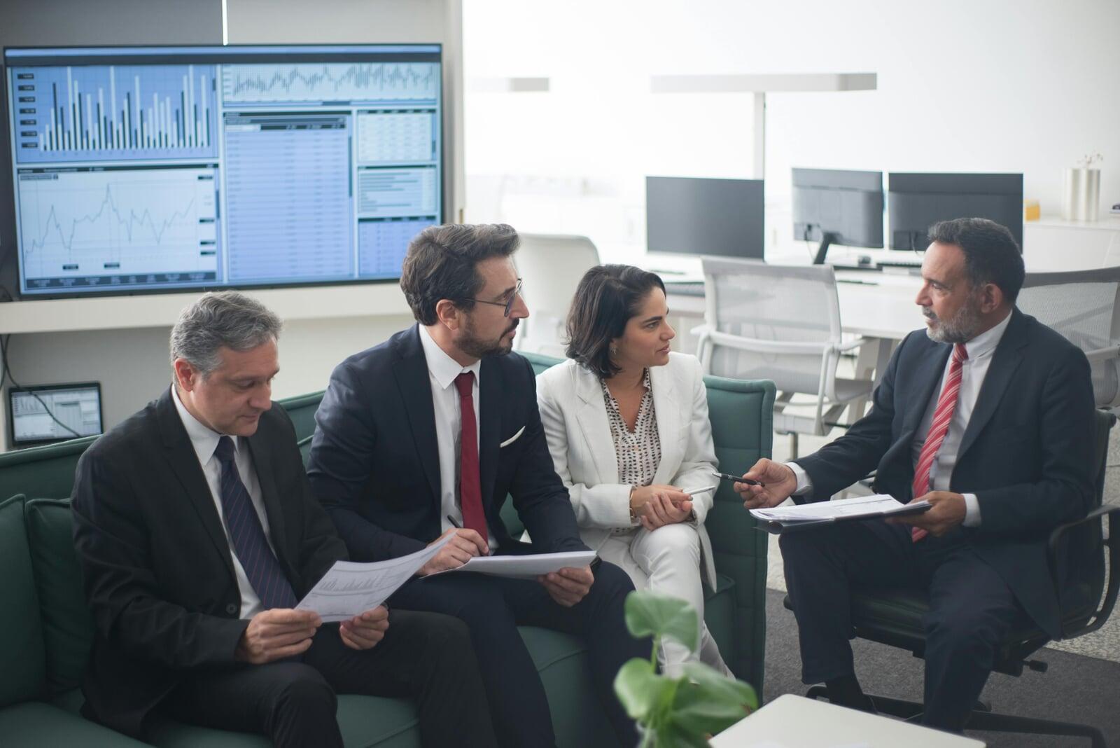 team collaborating over banking regulation and reducing risk