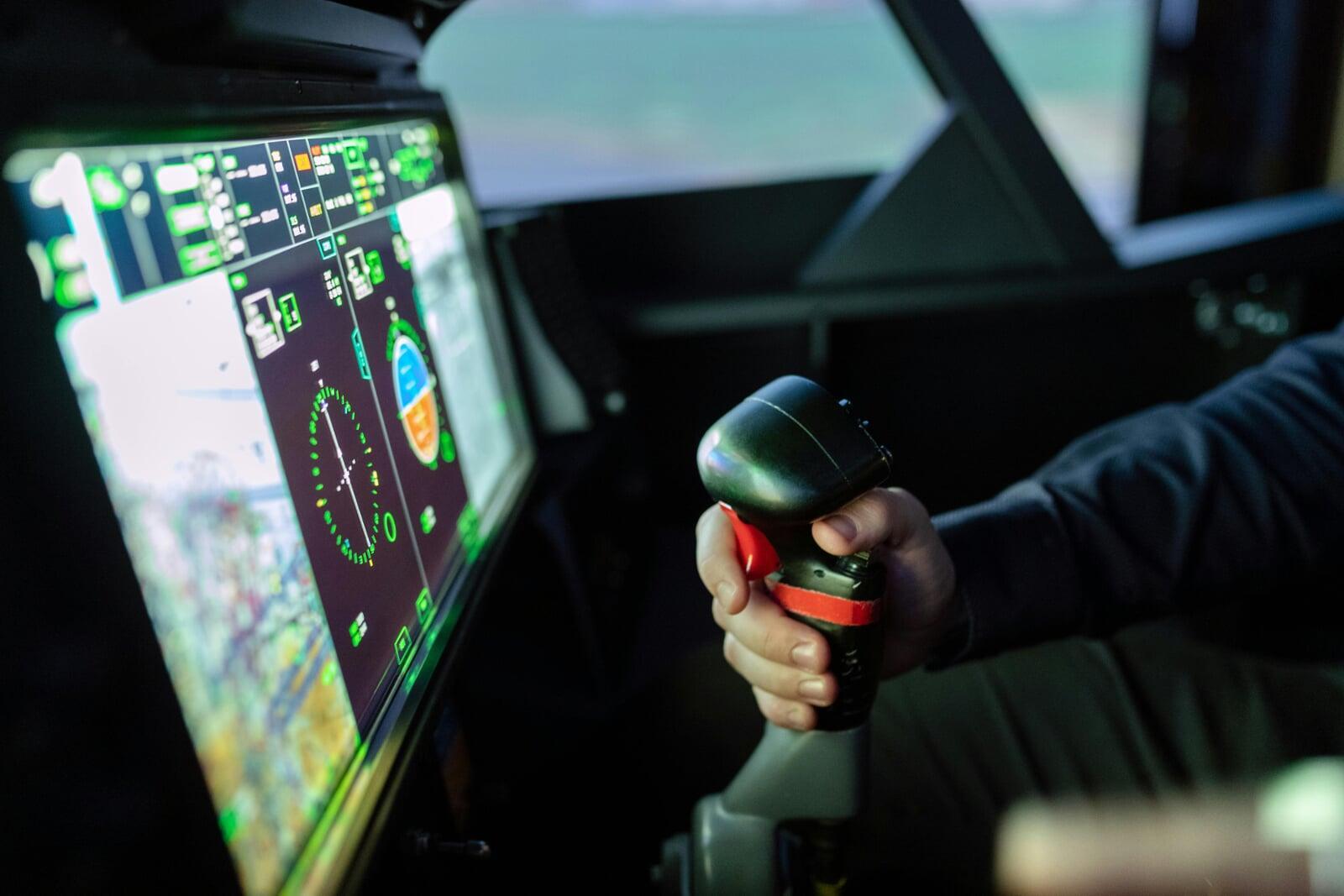 Engineers reviewing sustainability metrics with AI tools in aerospace